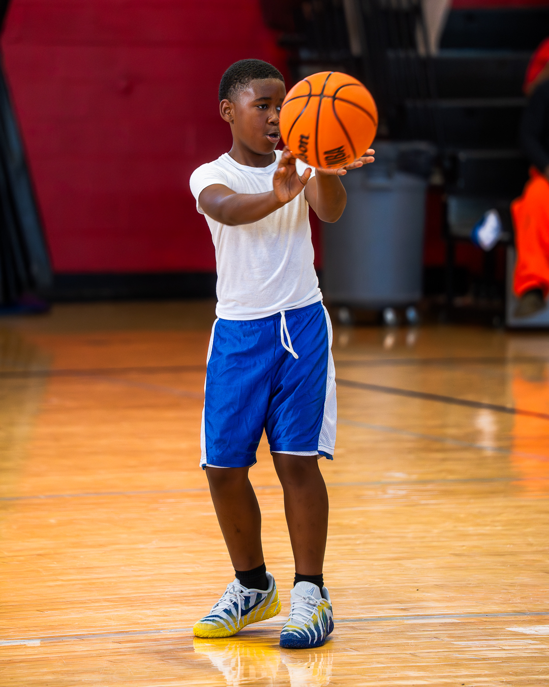 Little Lightning youth basketball player practicing his shooting form on the court